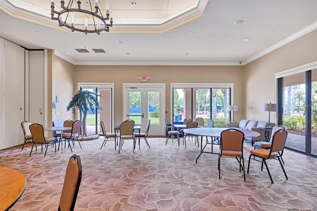 dining room with crown molding, an inviting chandelier, and french doors