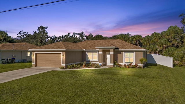 view of front of home featuring a yard and a garage