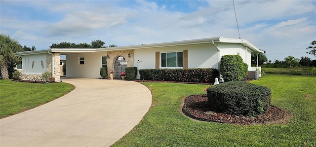 ranch-style house with a front yard and cooling unit