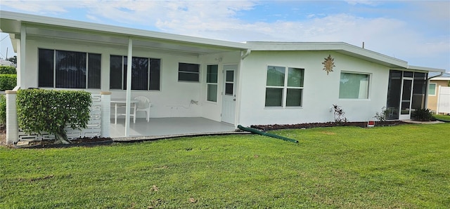 rear view of house featuring a yard and a patio