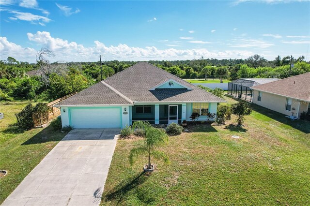 ranch-style home with a garage, covered porch, and a front yard