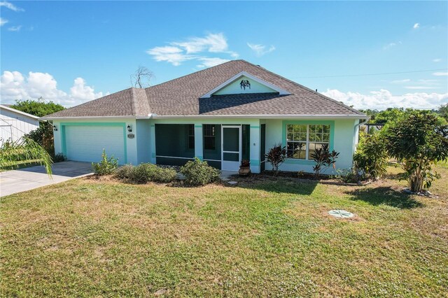 ranch-style home featuring a garage and a front lawn