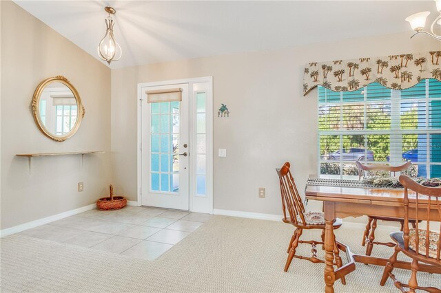 carpeted entrance foyer with a chandelier