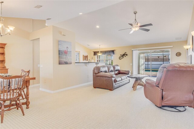 living room with ceiling fan with notable chandelier, lofted ceiling, and carpet flooring