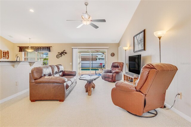 living room featuring carpet, lofted ceiling, ceiling fan, and sink