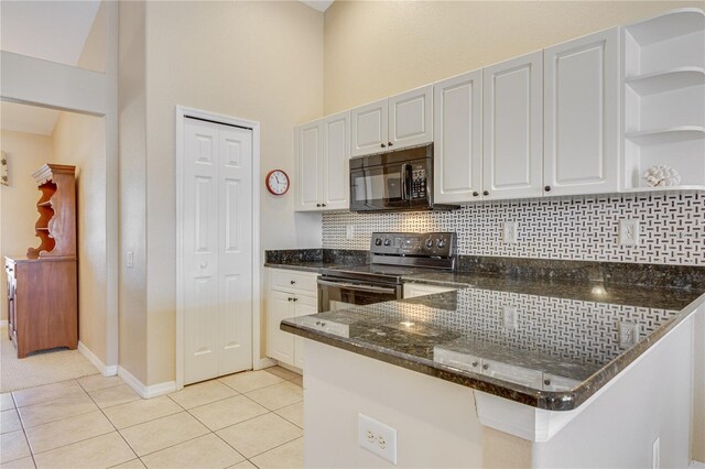 kitchen featuring light tile patterned floors, kitchen peninsula, white cabinetry, stainless steel electric stove, and decorative backsplash