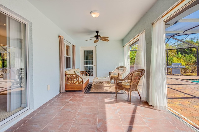 sunroom / solarium featuring ceiling fan