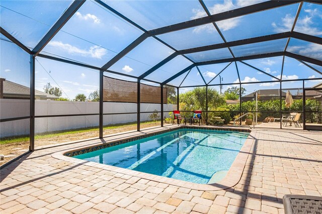 view of swimming pool with a lanai and a patio area