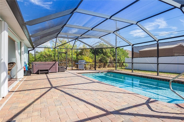 view of pool with area for grilling, a hot tub, a lanai, and a patio area