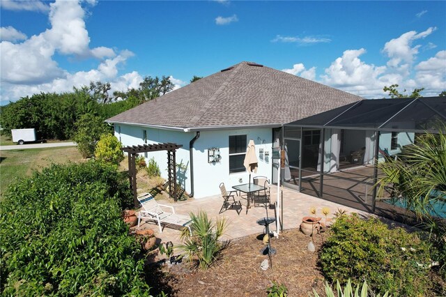 back of house with a lanai, a pergola, and a patio area