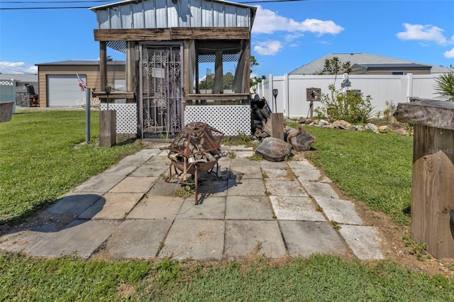 view of patio / terrace with a garage and an outdoor structure