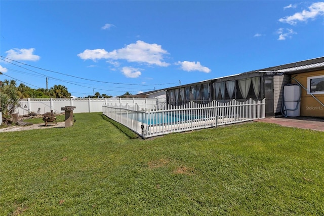 view of pool with a yard