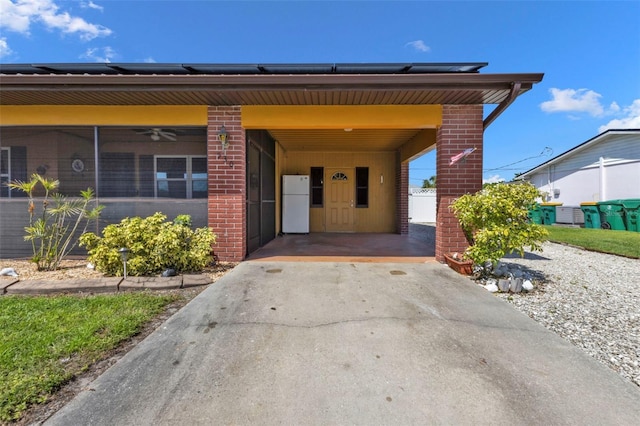 view of exterior entry with a carport