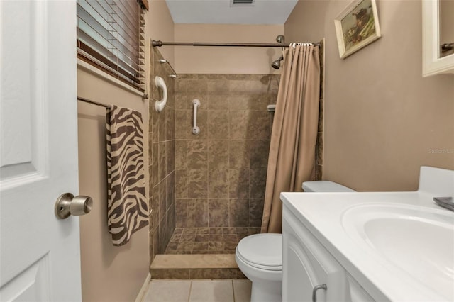 bathroom with vanity, a shower with curtain, toilet, and tile patterned floors