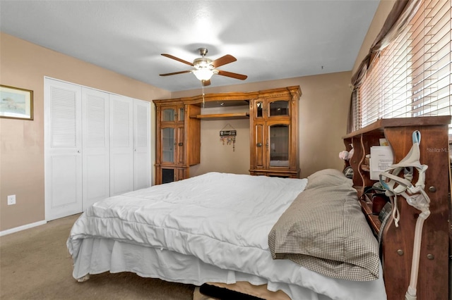 bedroom featuring light carpet and ceiling fan