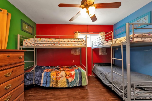 bedroom with dark wood-type flooring and ceiling fan