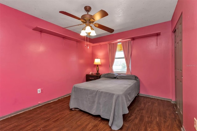 bedroom featuring a closet, ceiling fan, and dark hardwood / wood-style floors