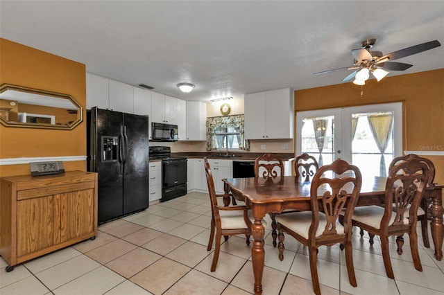 kitchen featuring white cabinetry, black appliances, light tile patterned flooring, and french doors