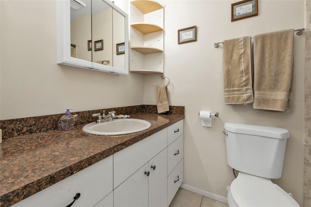 bathroom with vanity, toilet, and tile patterned floors