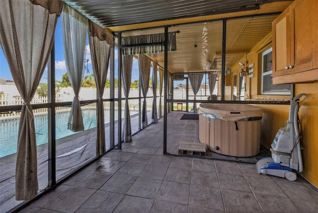 unfurnished sunroom with plenty of natural light and a jacuzzi