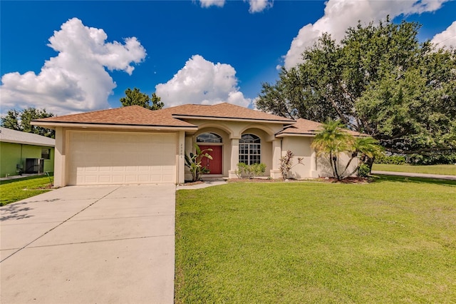 view of front facade featuring a garage, central AC unit, and a front yard