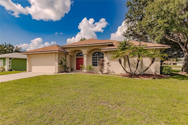 mediterranean / spanish home with a garage and a front lawn