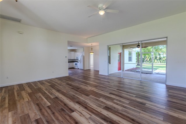 unfurnished living room featuring ceiling fan and dark hardwood / wood-style floors