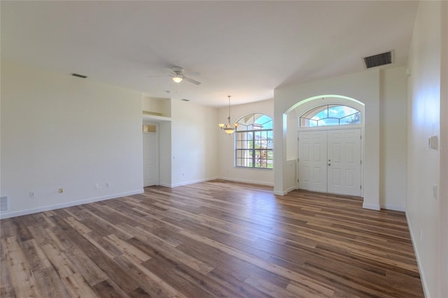 foyer entrance with ceiling fan with notable chandelier and hardwood / wood-style floors