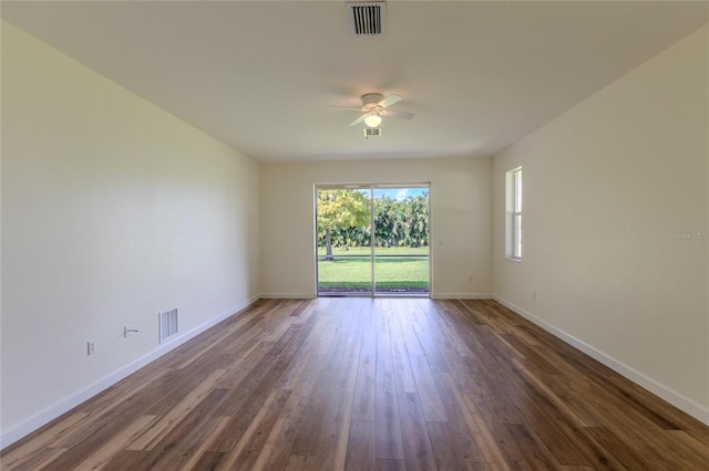 unfurnished room with ceiling fan and dark hardwood / wood-style flooring