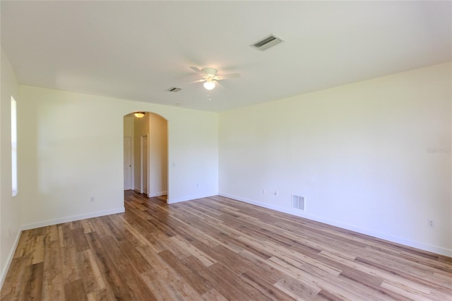 empty room featuring light wood-type flooring and ceiling fan