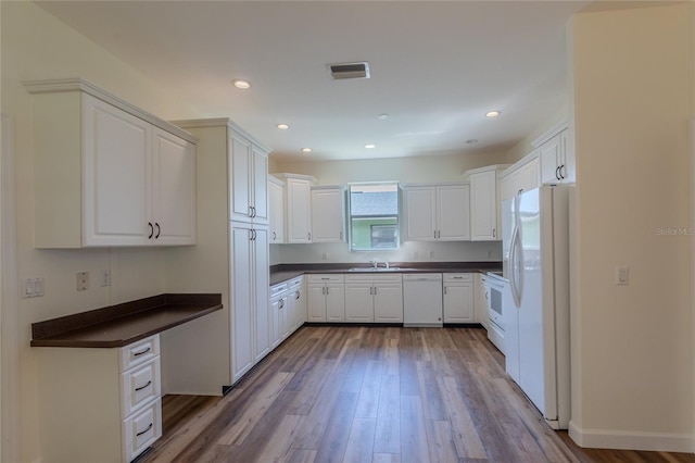 kitchen featuring white cabinets, light hardwood / wood-style flooring, sink, and white appliances