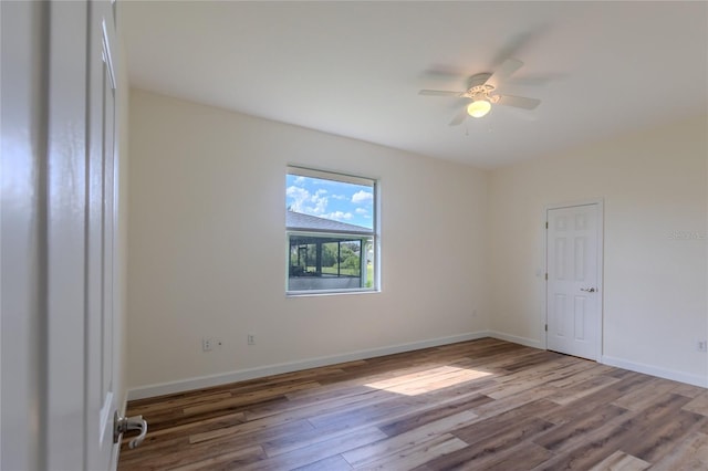 empty room featuring wood-type flooring and ceiling fan