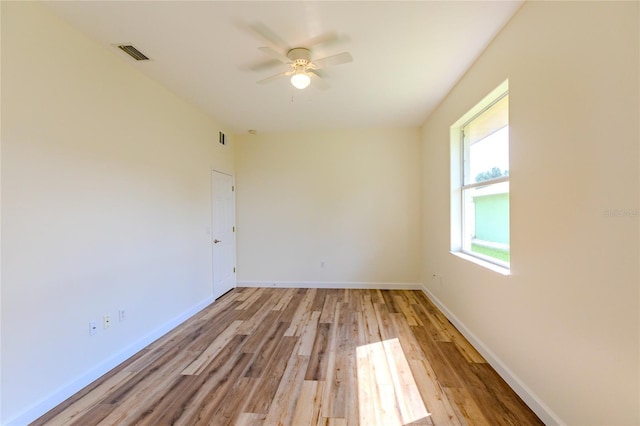 empty room with ceiling fan and light wood-type flooring