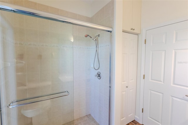 bathroom with a shower with door