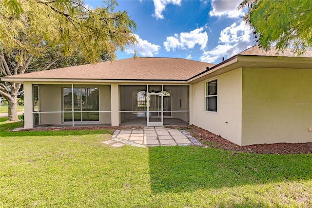 back of property with a lawn and a patio area