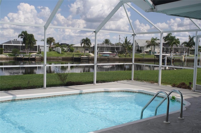 view of swimming pool featuring a water view, glass enclosure, and a lawn