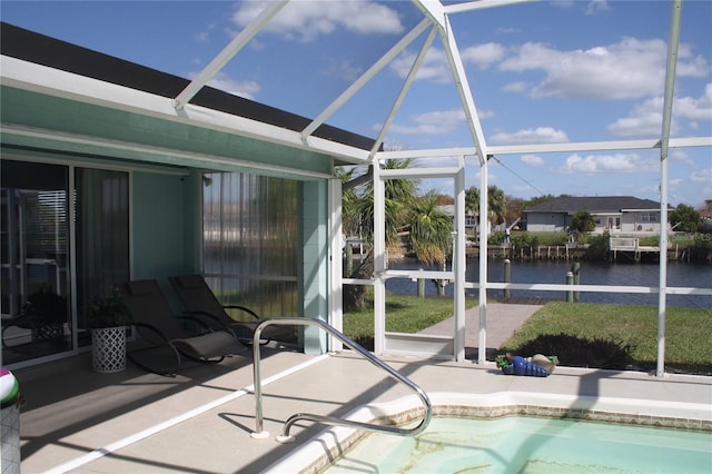 view of pool with a lanai, a water view, and a patio area