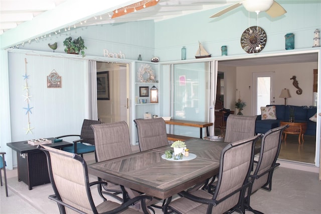 dining area featuring ceiling fan and vaulted ceiling with beams