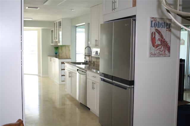 kitchen featuring white cabinetry, appliances with stainless steel finishes, sink, and backsplash