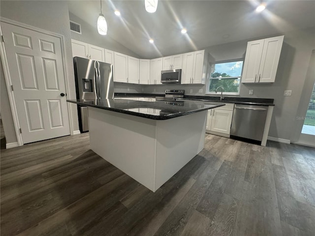 kitchen with a kitchen island, white cabinets, dark hardwood / wood-style floors, and stainless steel appliances