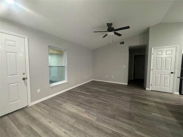 spare room featuring ceiling fan, dark wood-type flooring, and lofted ceiling