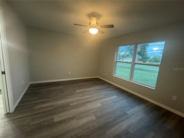 spare room with ceiling fan and dark hardwood / wood-style flooring