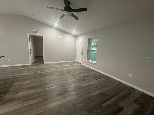 empty room with ceiling fan, dark hardwood / wood-style floors, and lofted ceiling