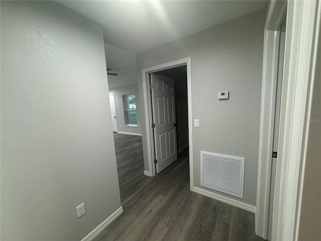 corridor featuring dark wood-type flooring