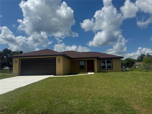 view of front of house featuring a garage and a front lawn