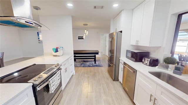 kitchen featuring pendant lighting, stainless steel appliances, white cabinetry, and extractor fan