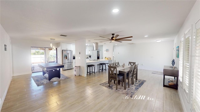 dining room with light wood-type flooring and ceiling fan