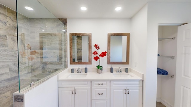 bathroom with vanity and tiled shower