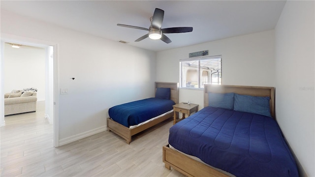 bedroom featuring ceiling fan and light hardwood / wood-style flooring