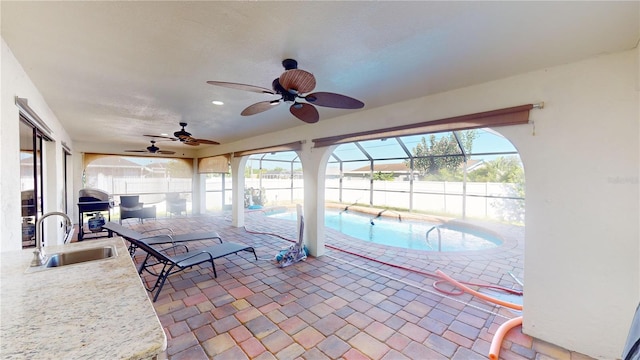 exterior space featuring sink, ceiling fan, and a wealth of natural light